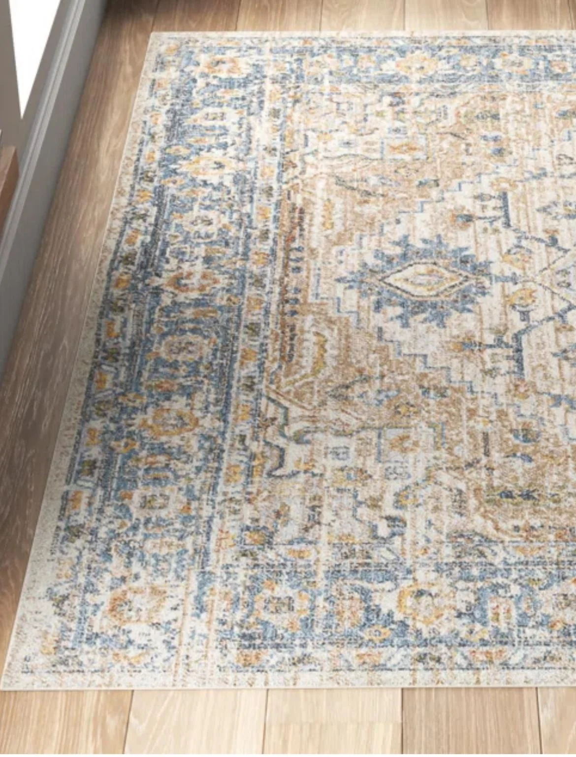 Blue and gold distressed Oriental rug on hardwood floor